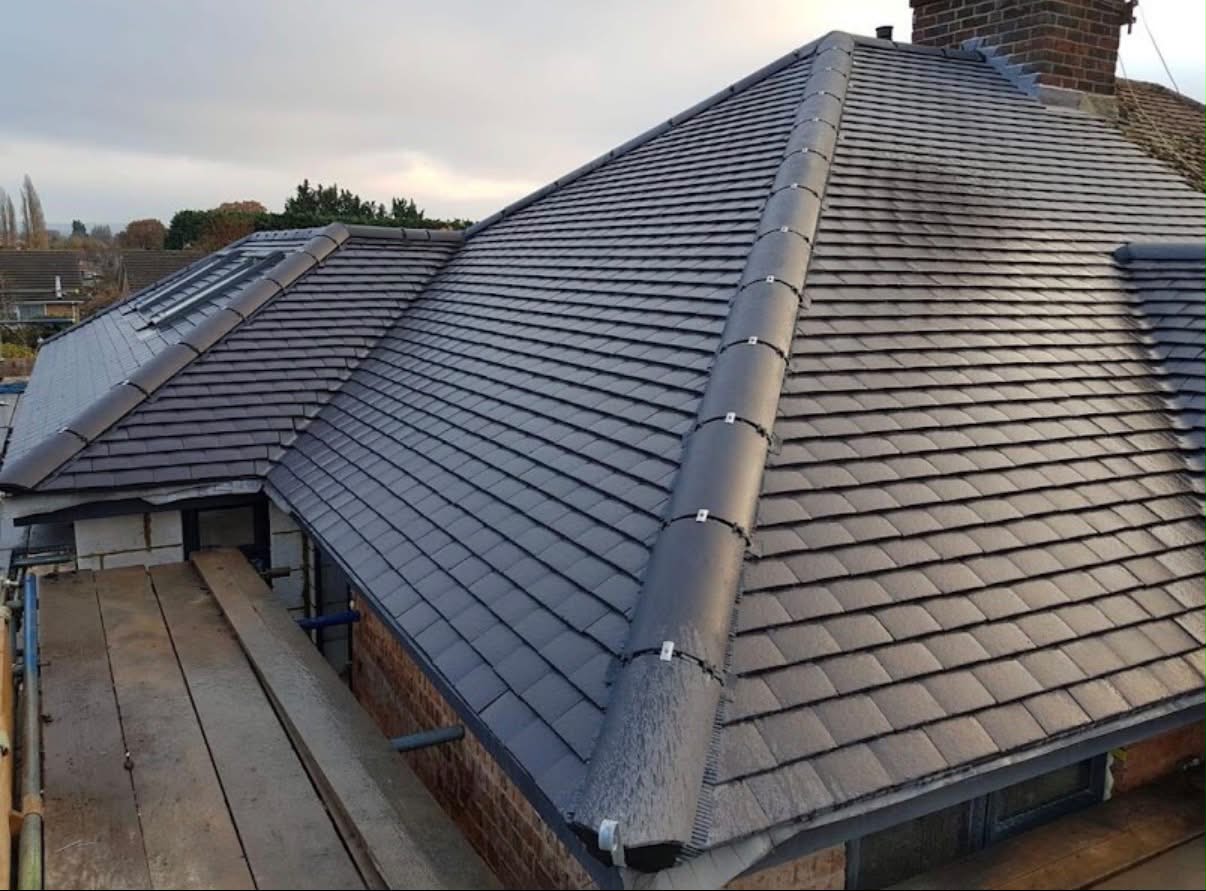 Completed flat roof junction with charcoal tiles and a skylight