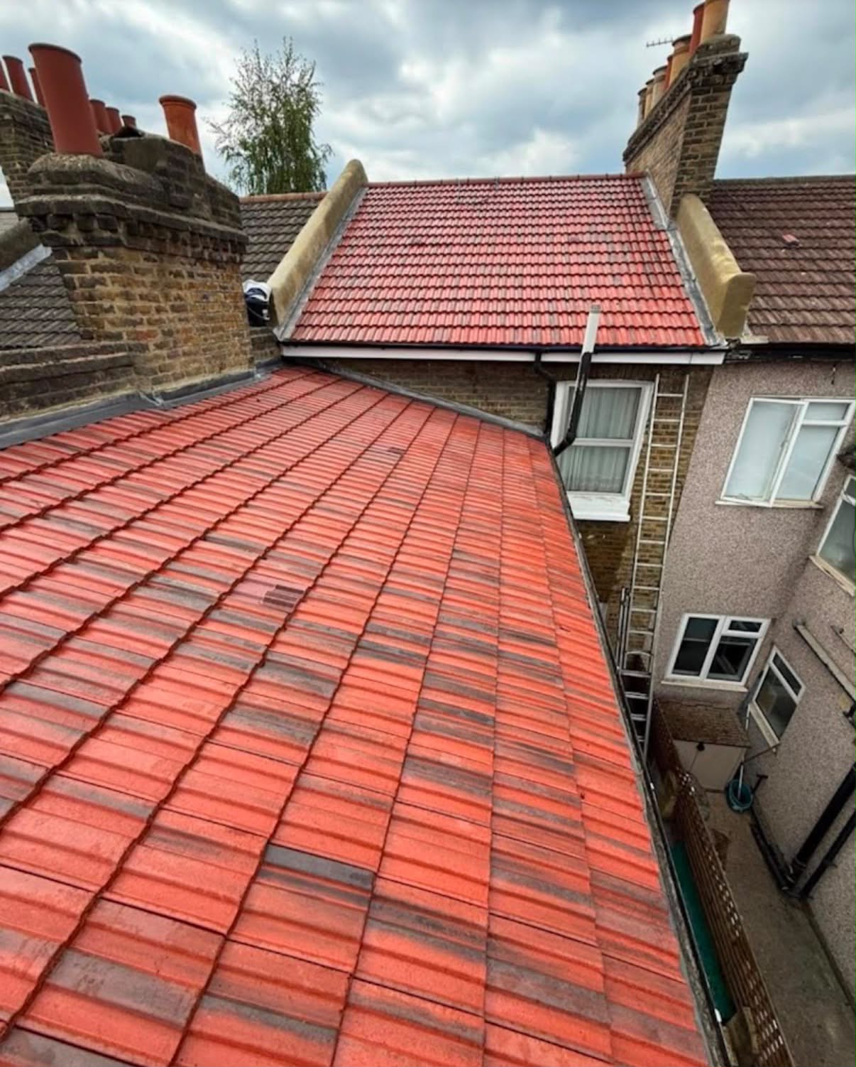New terracotta tiles with fresh lead flashing around the chimney